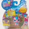 A set of mini posable animal figures in pink and purple, packaged with instructions.