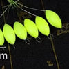 A string of bright yellow oval fishing floats with bobber beads is shown against a dark background.
