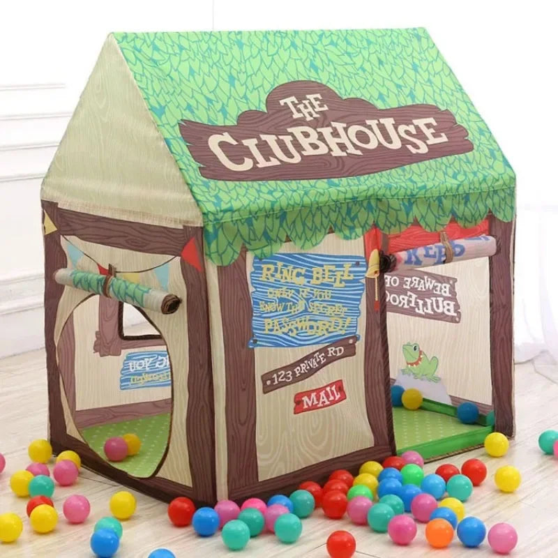 A foldable kids play tent shaped like a wooden house with green fabric and various colorful play items.