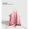 Pink mini backpack with a mushroom print design shown from the back