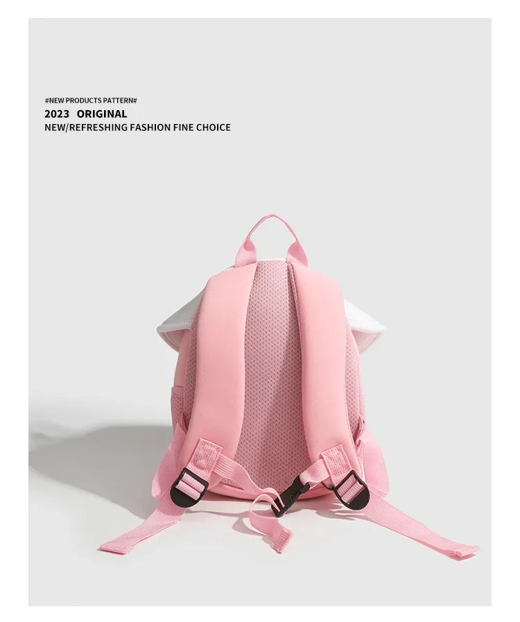 Pink mini backpack with a mushroom print design shown from the back