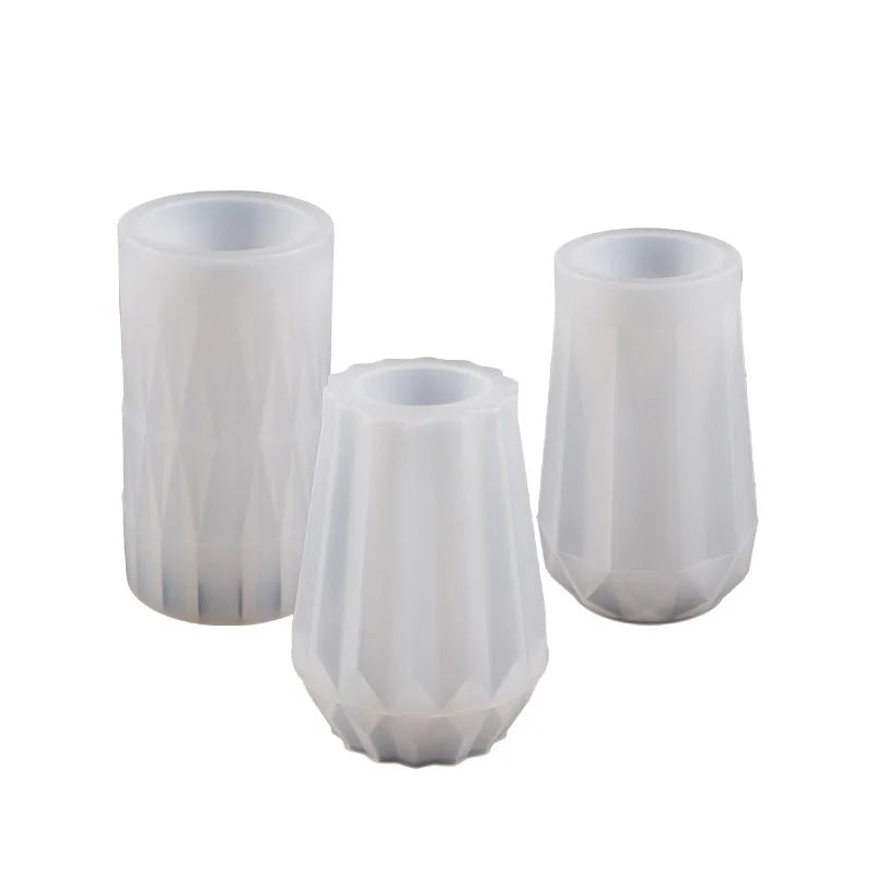 Two white flexible silicone molds shaped like flower pots for DIY concrete projects