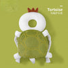 A soft security pillow backpack shaped like a tortoise with a crown, featuring green and white textures.