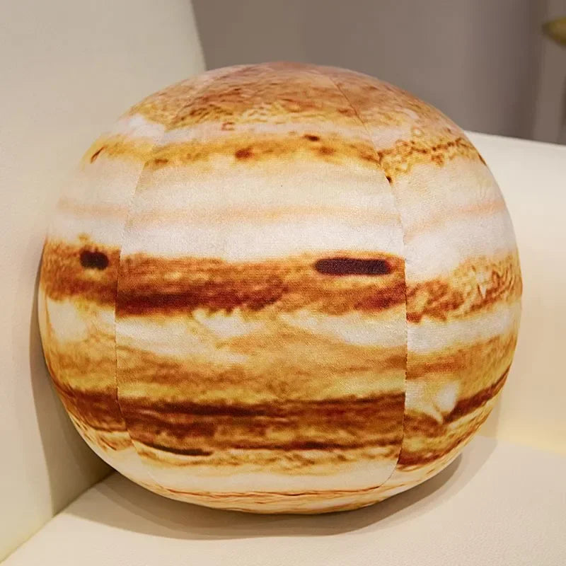 A round plush toy depicting the solar system with striped orange and white bands.