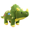 A soft green dinosaur plush toy with yellow accents and colorful embroidered spots.