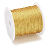 A spool of metallic gold craft cord or wire for jewelry making
