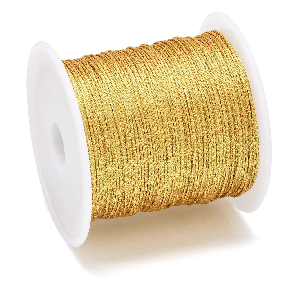 A spool of metallic gold craft cord or wire for jewelry making