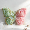 A silicone mold shaped like a butterfly and a rose, used for making candles and DIY crafts.