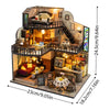 A wooden miniature dollhouse assembly kit featuring detailed furniture and an interior scene.