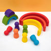 A collection of soft silicone rainbow building blocks in various colors like purple, green, red, yellow, and orange arranged 