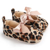 Pair of leopard print soft sole baby sneakers with pink satin bows