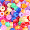 A close-up of a large pack of colorful rainbow pony beads in various shades of pink, purple, orange, and green.