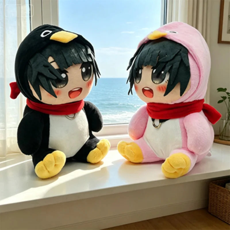 A pair of plush penguin toys, one black and white with yellow feet, and one pink with black hair and a red scarf.