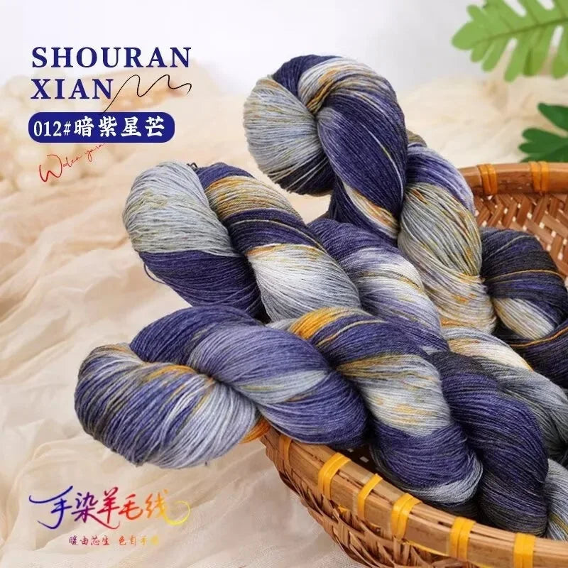 A bundle of hand-dyed Australian wool yarn featuring a blue and gray gradient color, displayed in a woven basket.