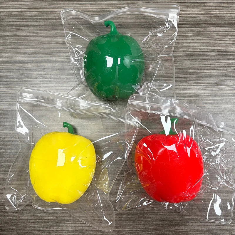 Three plastic bags contain green, yellow, and red bell peppers used as fidget toys