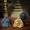 A handcrafted Aztec death whistle featuring a skull design, displayed on brown fabric.