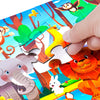 A hand is assembling a colorful jigsaw puzzle featuring various animal cartoon characters like an elephant, lion, and giraffe