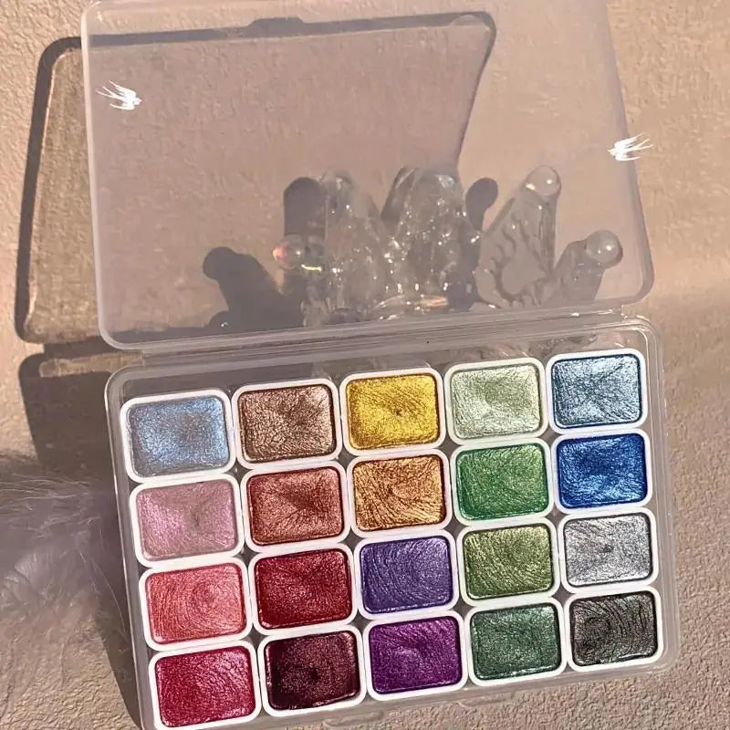 A collection of 20 metal watercolor paints in various shades and finishes displayed in a clear plastic box.
