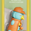 An orange and light blue duck and elephant bath toy with a suction cup, shown in a yellow frame.