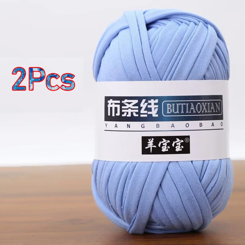 A skein of light blue soft chunky t-shirt yarn for crochet and knitting, packaged as a 2-pack.