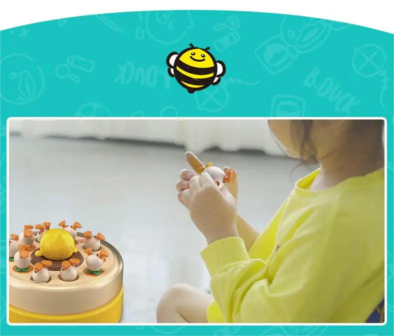 A child is interacting with a yellow and orange reflex training toy shaped like a duck, demonstrating fine motor skills.
