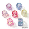 A collection of colorful acrylic alphabet beads in various shades of purple, pink, and clear are displayed on a white backgro