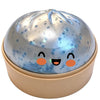 A round, shiny silver squishy toy shaped like a dumpling with cute orange facial features.