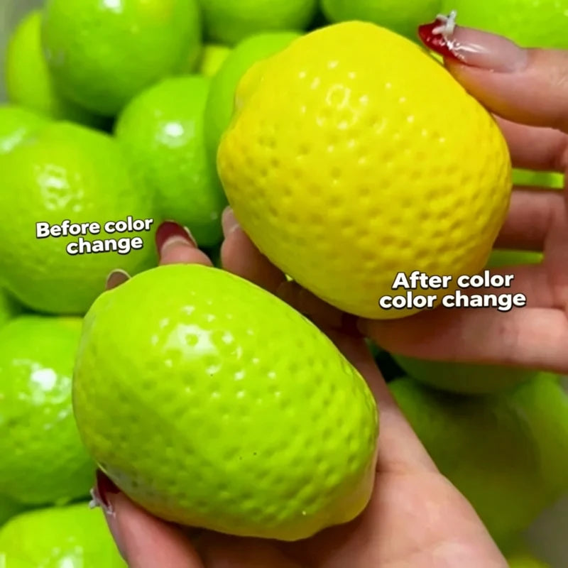 Hands hold a bright yellow lemon stress ball next to a green one, demonstrating a color change.