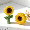 A bright yellow silicone sunflower mold with a dark center sits on a white surface.