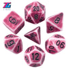 A set of pink and purple retro polyhedral dice showing various numbers like 5, 6, 8, 10, 12, and 20.