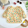 A full-sleeve waterproof baby bib with a cute cartoon design featuring various colored polka dots.