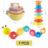 A set of seven colorful boat-shaped stacking cups for toddlers, including a stackable cup and individual cups.