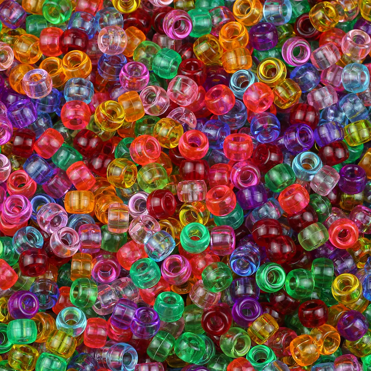 A close-up view of many small, solid color pony beads in various shades of red, green, purple, and orange.