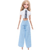A fashion doll wearing a white cropped top with black text and light blue denim pants.