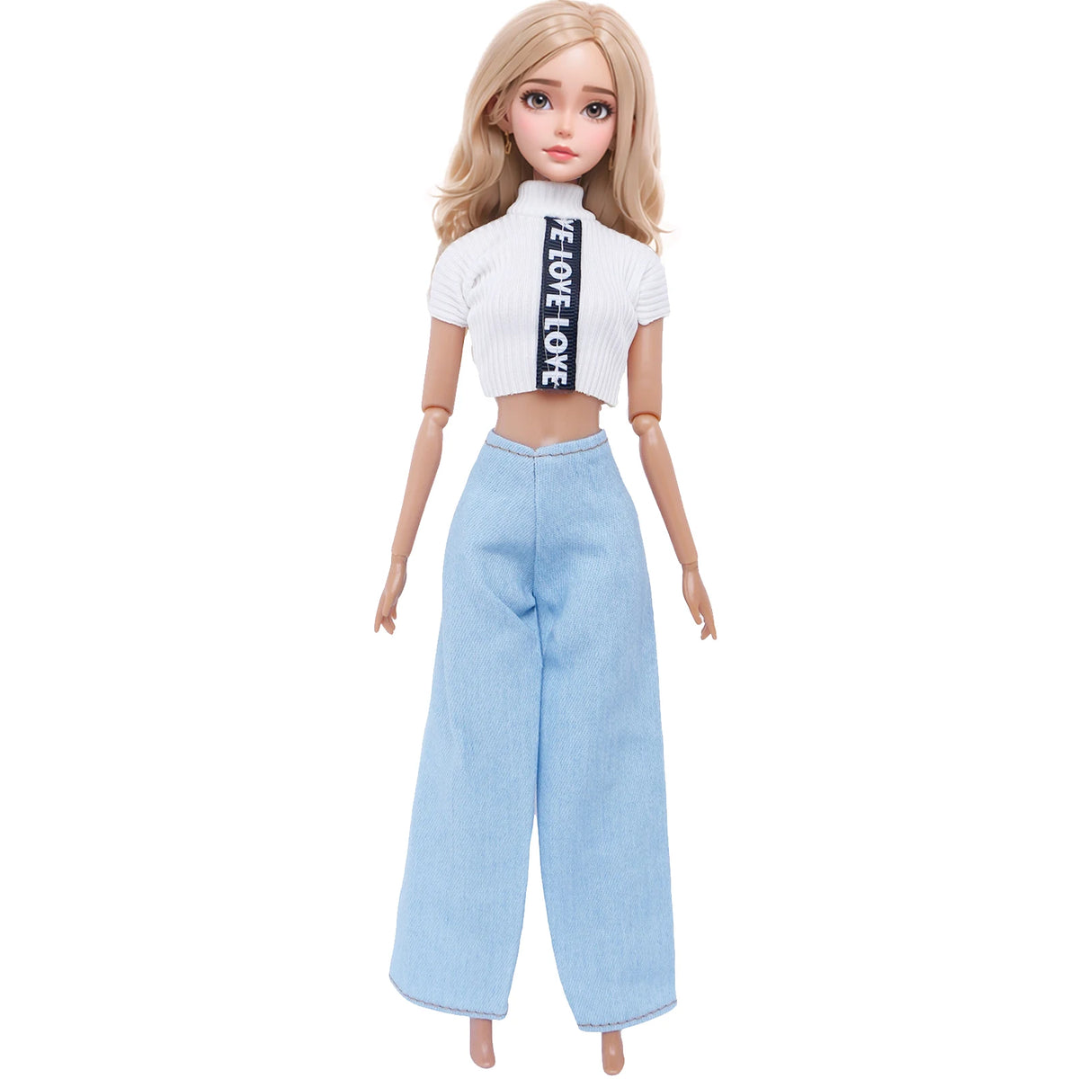 A fashion doll wearing a white cropped top with black text and light blue denim pants.