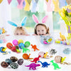 A collection of colorful dinosaur eggs and toys displayed on a white surface.