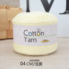 A ball of light yellow cotton yarn labeled as 100% Cotton Yarn for knitting and crochet.