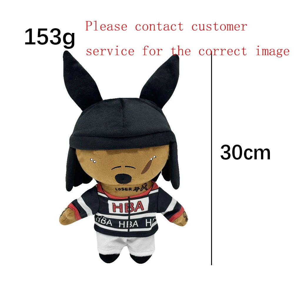 A dark plush doll resembling Eminem, XXXTentacion, and Frank Ocean with black hair and clothing.