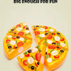 A bright yellow pizza-shaped food item decorated with colorful fruit and vegetable toppings.