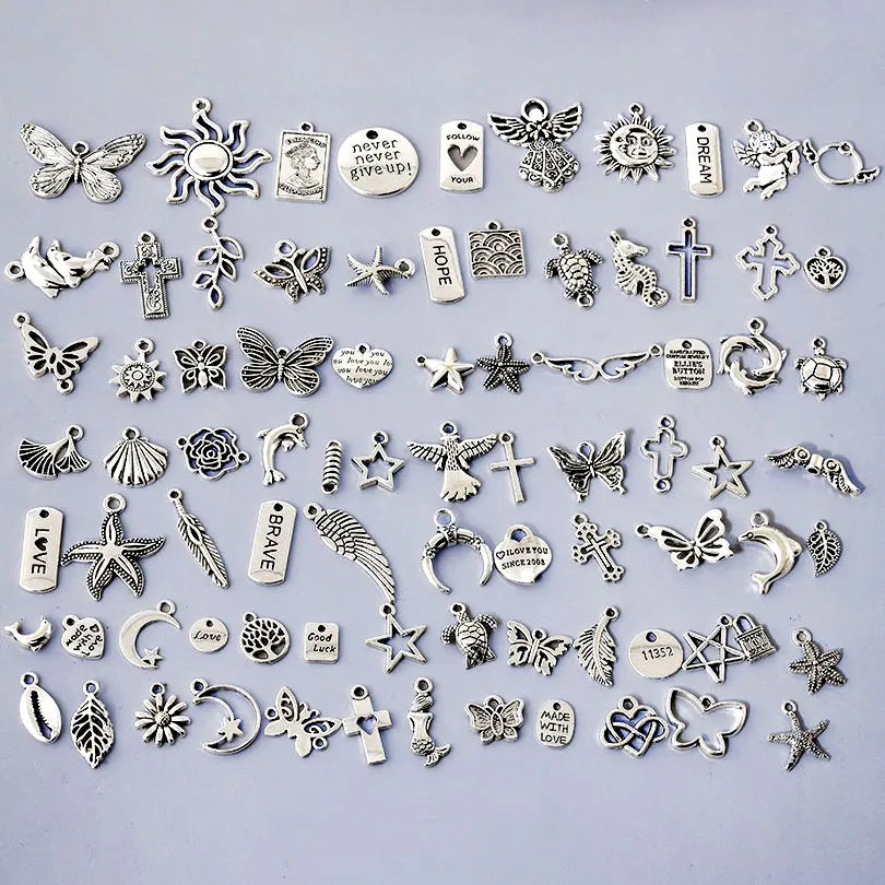 A collection of mixed metal charms for DIY jewelry making featuring various shapes and symbols.
