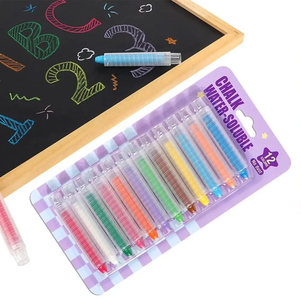 A set of 12 chalk water-soluble crayons in a plastic case is shown next to a blackboard with chalk drawings.