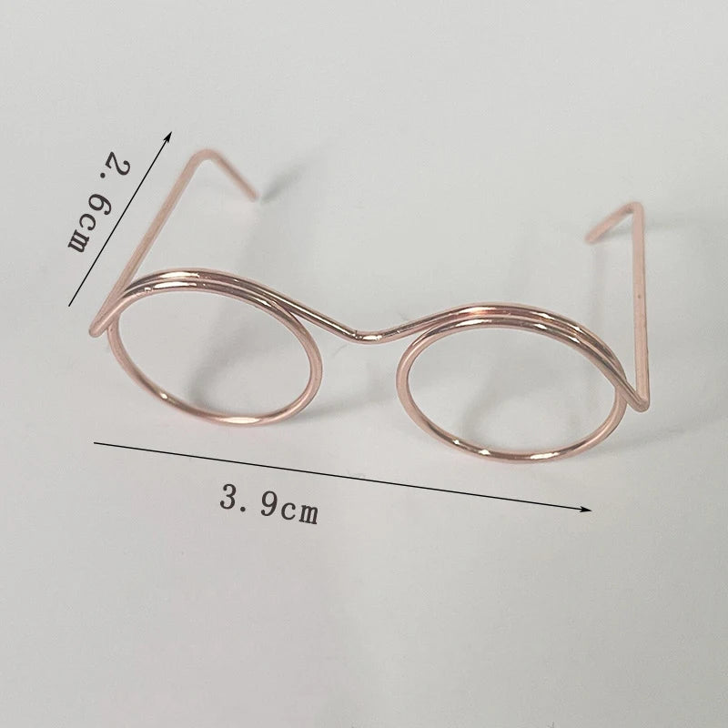 A pair of rose gold metal round glasses frames shown with dimensions 2.6cm and 3.9cm.