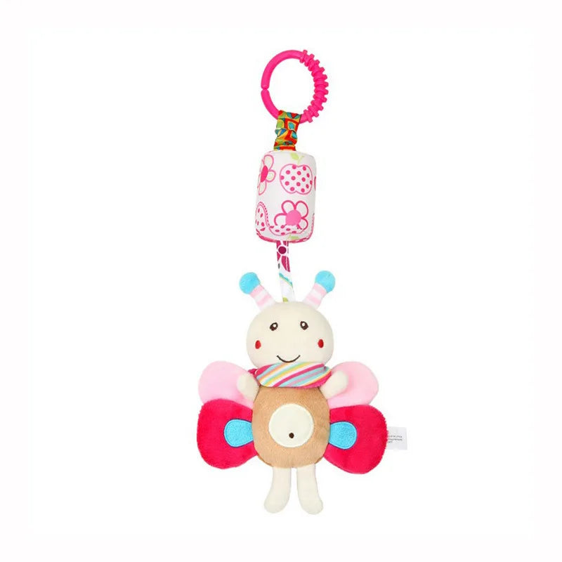 A plush hanging rattle toy with a pink ring and colorful accents.