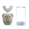 A gray elephant-shaped electric toothbrush with a U-shaped brush head and a clear cylindrical charging base emitting blue lig