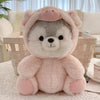 A pink husky plush toy with soft fur is sitting on a white lace tablecloth.