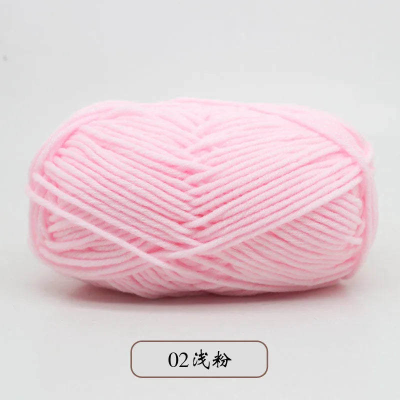 A ball of pink pre-dyed milk cotton yarn used for knitting and crochet.