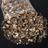 A pile of assorted gold and silver metal pendants for jewelry making inside a clear plastic bag.