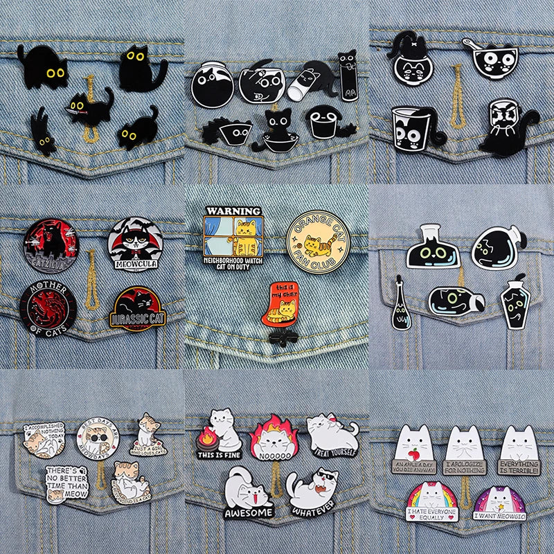 A collection of enamel pins featuring various cats in different expressions and styles.