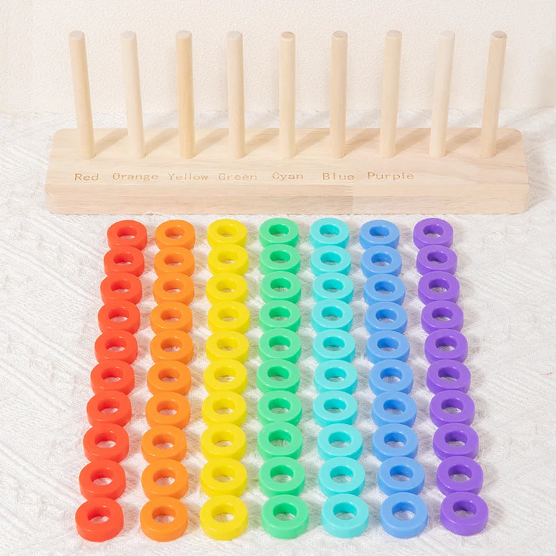 A wooden ring toss game with colored rings in various shades of red, orange, yellow, green, cyan, blue, and purple.
