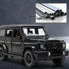 A black diecast metal RV camper truck model is shown in a side view against a dark background.